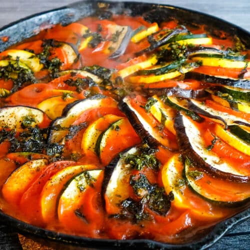 A colorful dish of vegetables served in a cast iron skillet